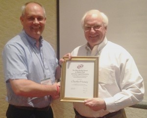 Robert Mantz (left), chair of the Physical and Analytical Electrochemistry Division of the Electrochemical Society, presents Charles Hussey with the society’s Max Bredig Award in Molten Salt and Ionic Liquids. Courtesy photo.