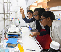 students and professor in lab